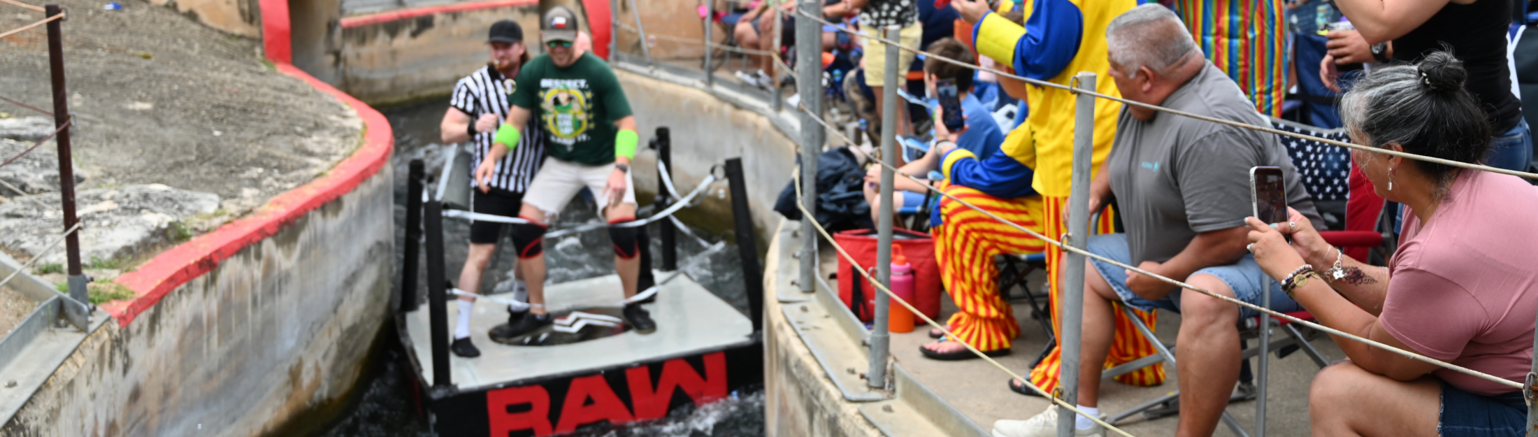 Thru the Chute Competitors dressed as wrestlers on their boat going down the tube chute