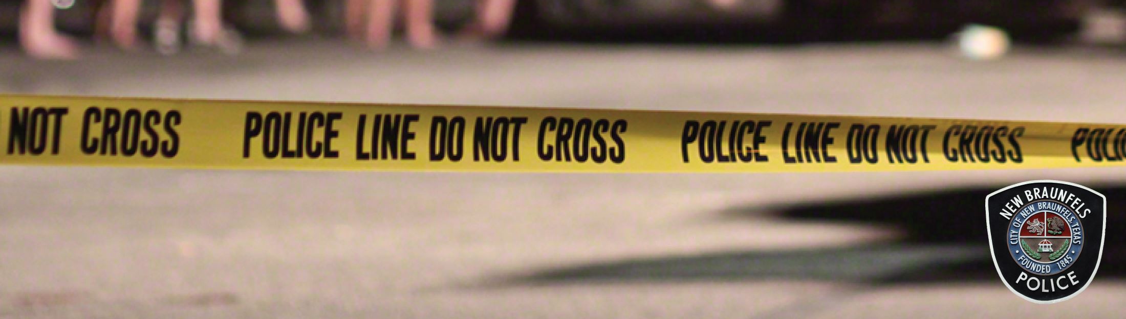 Plastic barricade that reads "Police Line Do Not Cross"