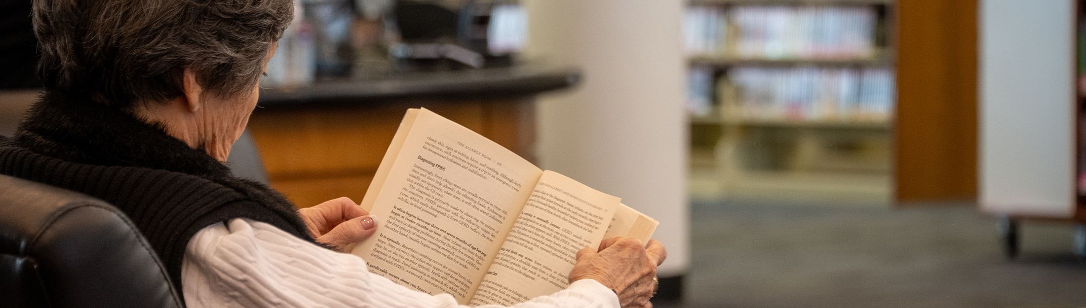 A woman reads a book at the New Braunfels Public Library
