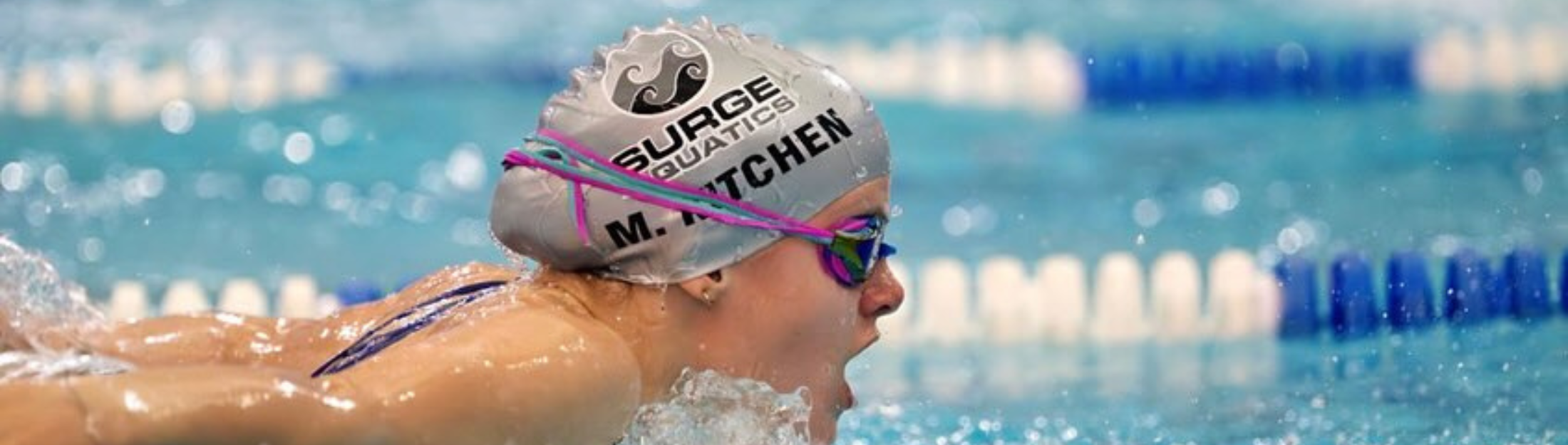 A swimmer pops their head above the water to breath while swimming laps at Das Rec