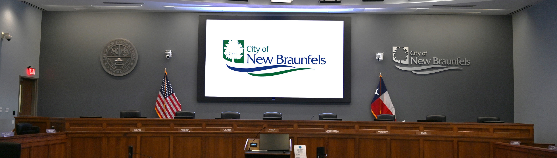 City Hall Council Chambers with New Big screen displaying the City of New Braunfels Logo (front)