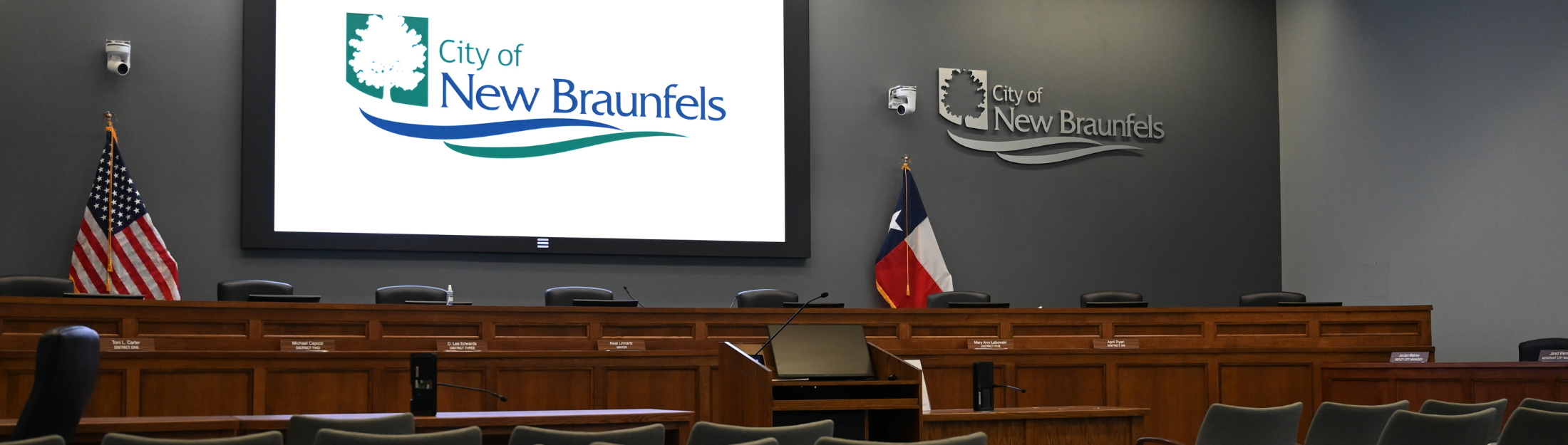 City Hall Council Chambers with New Big screen displaying the City of New Braunfels Logo (crowd)